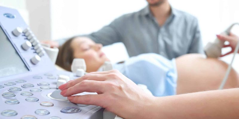 young-loving-pregnant-couple-visiting-doctor-together-2-1
